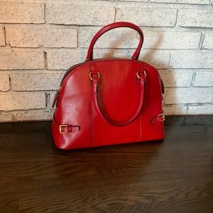 Never been used red leather bag with cross body attachment.